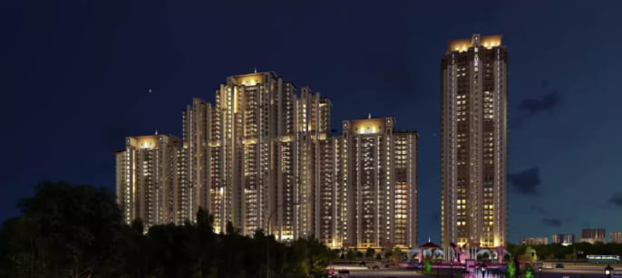 Night view of Gaur Island luxury residential towers with illuminated skyline in Greater Noida West
