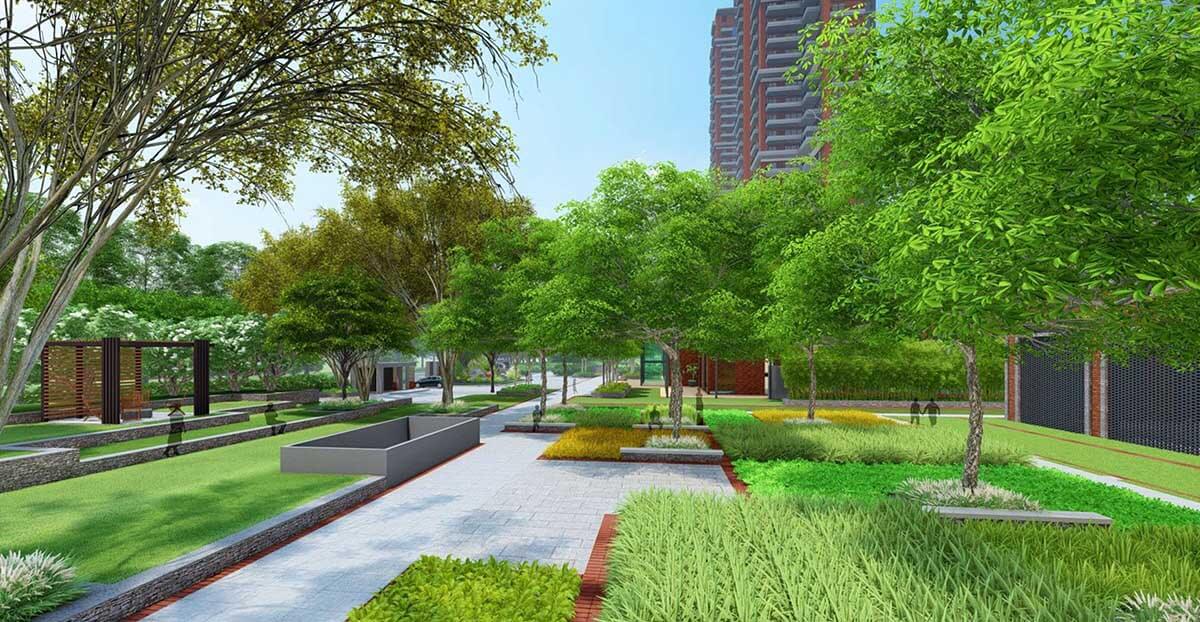 Beautifully landscaped community park with paved walking paths, manicured green lawns, dense trees, and seating areas