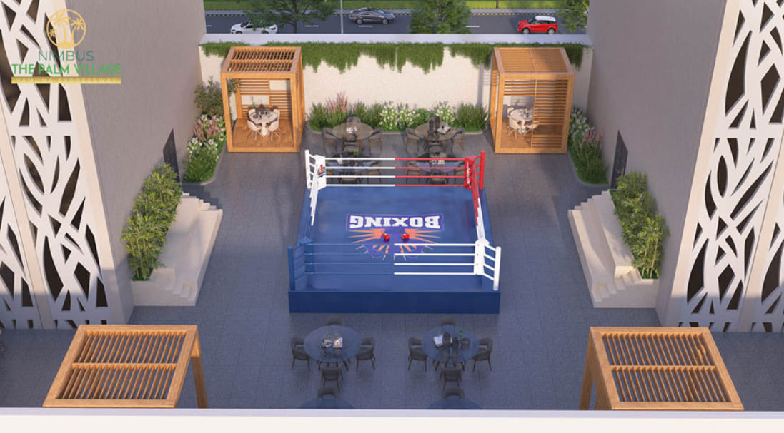Top-down rendering of an outdoor sports courtyard at Nimbus The Palm Village featuring a professional boxing ring and sitting gazebos