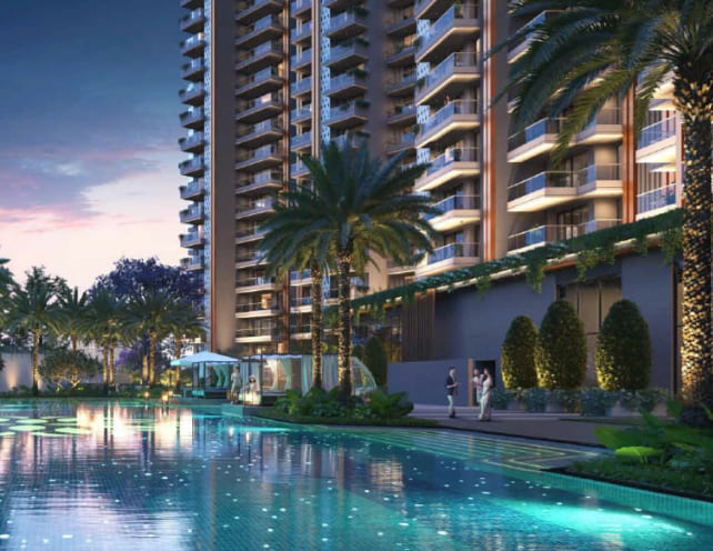 Premium outdoor swimming pool area at Northwind Sanctuary lit up at dusk, bordered by palm trees and high-rise residential blocks