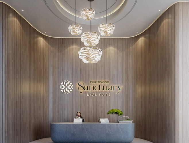 Elegant reception lobby desk at Northwind Sanctuary featuring the community branding slogan Live Rare on a wooden wall panel