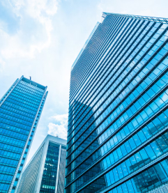 Modern glass office buildings against a blue sky